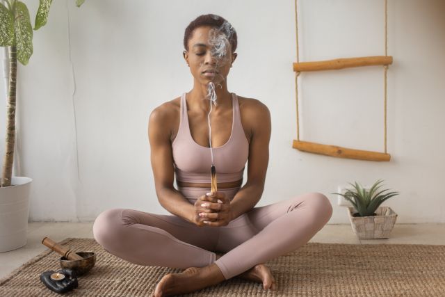 A Woman Doing a Yoga Ritual on a Yoga Mat