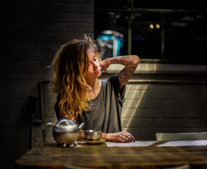 Woman Sitting Beside Table